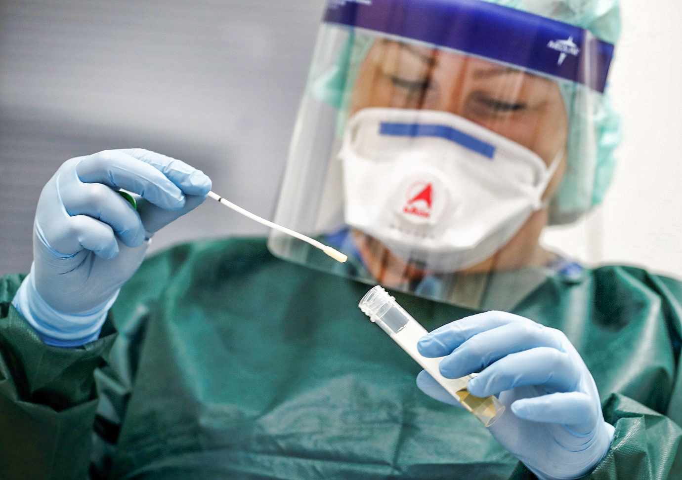 Canan Emcan, 31, chief nurse of the infection and virologist ward of the university clinic of Essen closes a sample of a smear test to be used in case of coronavirus patients during a media event in Essen, Germany, March 5, 2020.   REUTERS/Wolfgang Rattay