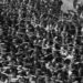 Employees of the shipyard Blohm und Vow from Hamburg gathered for the launch of the training ship 'Horst Wessel' and demonstrate the Nazi salute with the raised right arm. One worker in the right half of the picture denied it and crosses his arms in a defiant gesture - also a kind of resistance. The name of the worker is August Landmesser., 01.01.1936-31.12.1936
