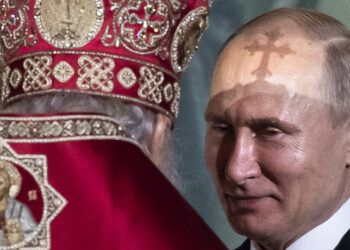 FILE  In this file photo taken on Sunday, April  28, 2019, President Vladimir Putin, right, listens to Russian Orthodox Patriarch Kirill, back to a camera, during the Easter service in the Christ the Savior Cathedral in Moscow, Russia. (AP Photo/Alexander Zemlianichenko, File)