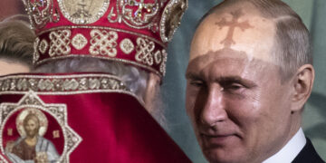 FILE  In this file photo taken on Sunday, April  28, 2019, President Vladimir Putin, right, listens to Russian Orthodox Patriarch Kirill, back to a camera, during the Easter service in the Christ the Savior Cathedral in Moscow, Russia. (AP Photo/Alexander Zemlianichenko, File)